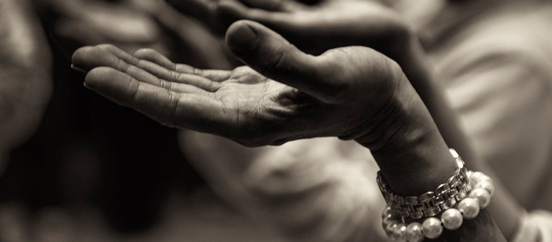 Woman worshipping with hands raised